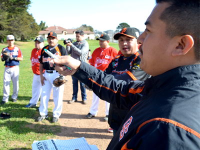 Gaspar Chi (far right), manager of San Francisco-based Club Yucatán, talks to his team before the game and announces the batting order. Photo:  Jonah Harris.
