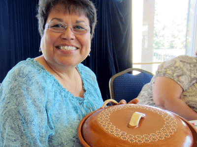 Customer in the East Bay shows her lead-free cazuela handmade by Mexican artisans.